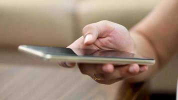 Stock footage of a woman typing on a mobile screen. video