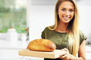 Woman with loaf of bread photo
