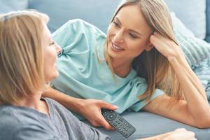 Two girl friends or lgbt couple in living room photo