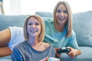 Two girl friends or lgbt couple in living room photo