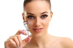 Picture showing woman using eyelash curler over white photo