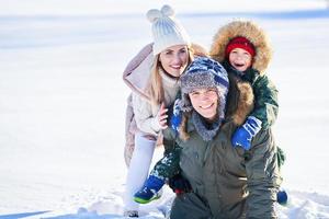 Nice happy family having fun on winter snow photo