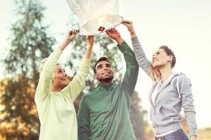 Group of friends floating chinese lanterns photo