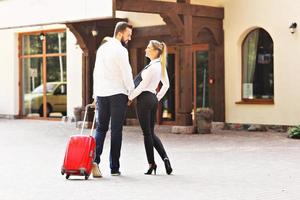 Pretty couple entering hotel photo