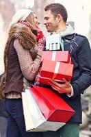 Happy couple shopping for Christmas in the city photo