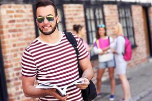 Group of happy students studying outdoors photo