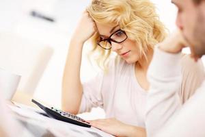 Worried couple with documents at home photo