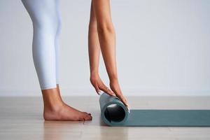 Adult beautiful woman working out over light background photo