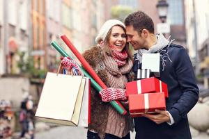 Happy couple shopping for Christmas in the city photo