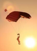 Person parachuting on the sunset photo