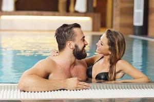 Happy couple relaxing in pool spa photo