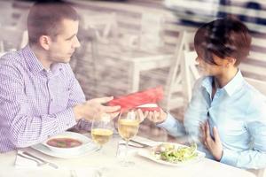 Man giving present in a restaurant photo