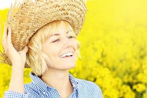 Happy woman on a yellow rape field photo