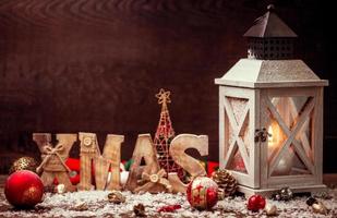 Christmas Lantern on snowy table with festive decoration. photo