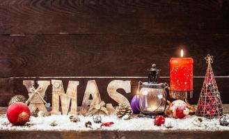 Christmas Lantern on snowy table with festive decoration. photo