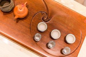 Asian tea set on bamboo wooden background. Traditional Chinese tea ceremony accessories on the tea table photo