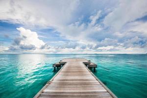 Jetty leads to the sea. Find your way and purpose in life. Wooden road and way to the future and new discoveries. Freedom, success, start concept. Rest, travel and enjoy life, relax view and calmness photo