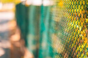 Steel fence, fragment of forged metal products with blurred nature background photo