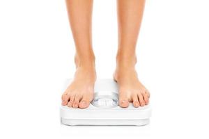 Woman feet on bathroom scales photo