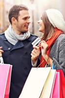 Couple shopping in the city with credit card photo