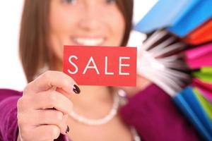 It's sale. Brunette woman with sale card photo