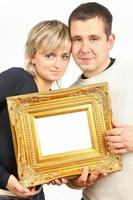 woman and man holding gold frame photo