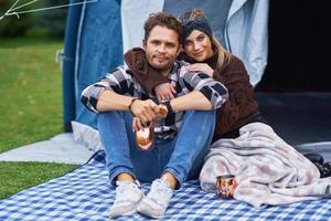 Young nice couple having fun on camping photo