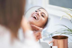 Young nice brunette woman in the bathroom photo