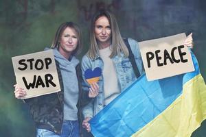 Two girls supports Ukraine with no war signs photo