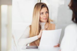 Young nice receptionist woman in salon spa or hotel photo