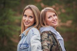 Two girl friends or lgnt couple in wood photo