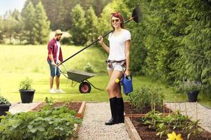 Young couple working in the garden photo