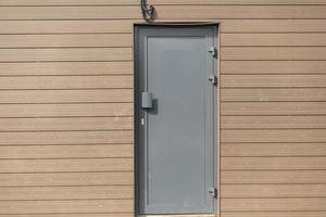 Technical entrance to building. Grey door. photo