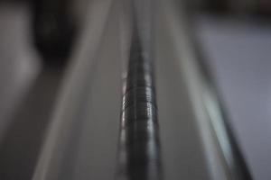 Carving on machine. Production details. Threaded screw. Macro photography of steel part. photo