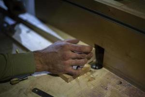 Wood processing. Carpenter's hand. Details of work in carpentry workshop. photo