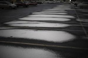 Snow in parking lot. Parking for cars in winter. photo