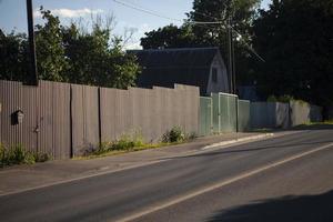 Road in countryside. Fences along highway. Details of summer outside city. photo