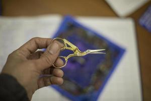 Fabric scissors. Small scissors in hand. photo