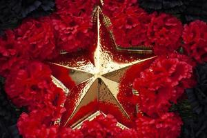 Gold star in colors. Symbol of Red Army. Details of military parade. photo