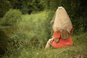 Girl on lake. Woman on nature. Holiday in park. photo