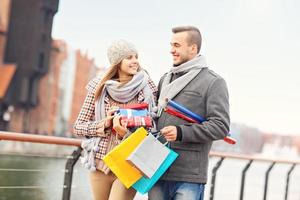 Romantic couple with presents in the city photo