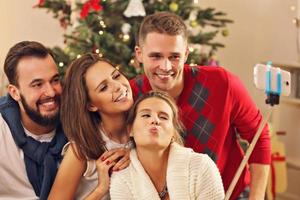 Group of friends taking selfie during Christmas photo