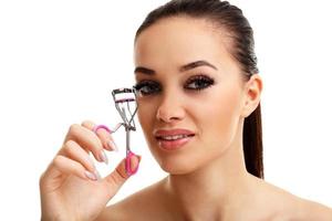 Picture showing woman using eyelash curler over white photo