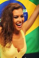 Happy Brazilian fan cheering with flag photo