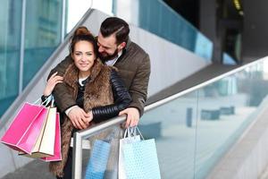 Happy couple shopping and hugging photo