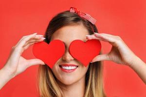 Sexy Valentine woman holding hearts photo