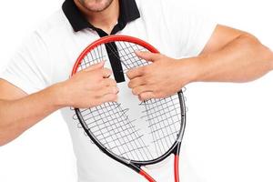 Angry tennis player tearing racket strings apart photo