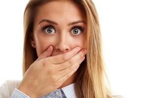 Afraid woman looking at camera isolated on a white background photo