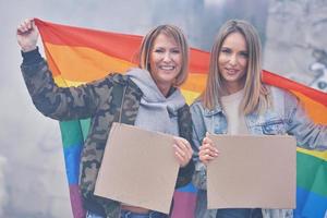 Lgbt couple with blank message board and flag photo