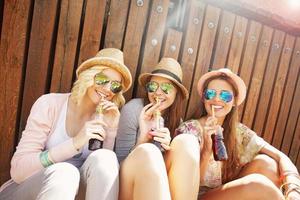 Group of friends drinking cocktails in the city photo